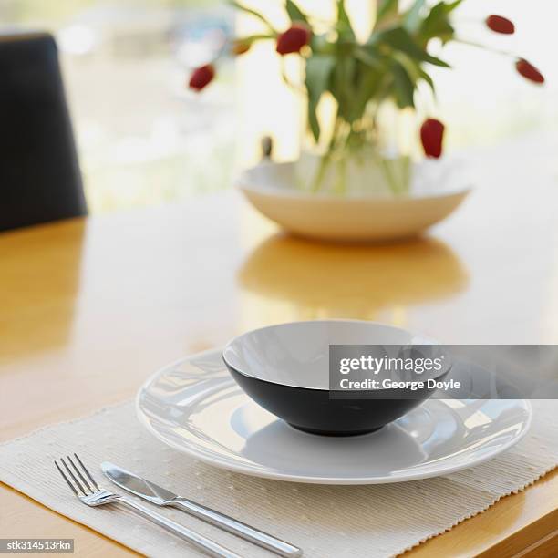 close-up of a place setting on a dining table - lily family stock-fotos und bilder