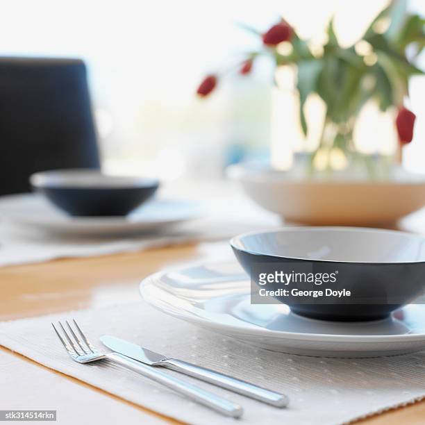 close-up of two place setting on a dining table - lily family stockfoto's en -beelden