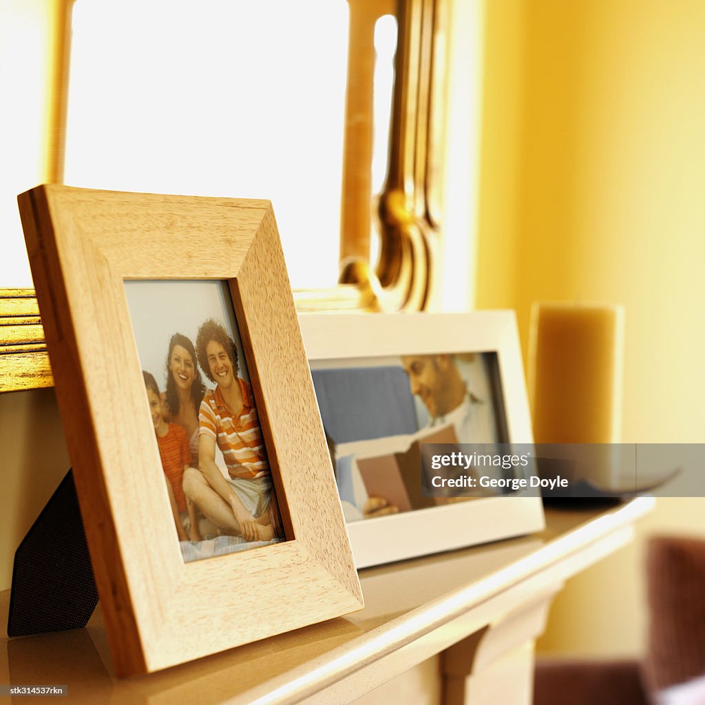 Close-up of picture frames on a mantelpiece