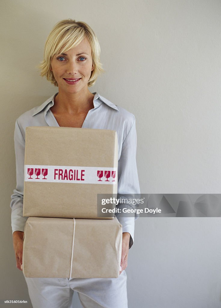 Portrait of a young woman holding packages