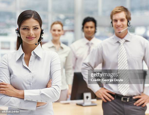 portrait of four business executives standing in an office - communication occupation stock pictures, royalty-free photos & images