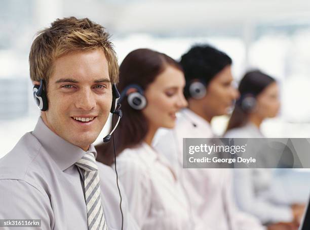 portrait of a businessman with three business executives sitting next to him - next stockfoto's en -beelden