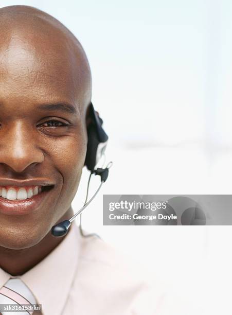 portrait of a businessman wearing a headset in an office - communication occupation stock pictures, royalty-free photos & images