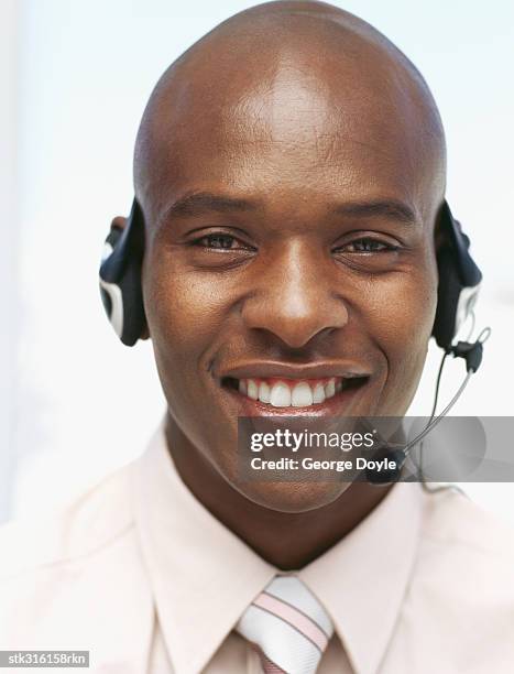 portrait of a businessman wearing a headset in an office - communication occupation stock pictures, royalty-free photos & images