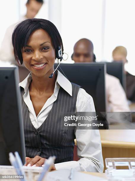 portrait of a businesswoman wearing a headset in an office - communication occupation stock pictures, royalty-free photos & images