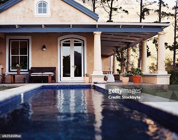 view of a swimming pool in the backyard of a house - kellyanne conway speaks to morning shows from front lawn of white house stockfoto's en -beelden