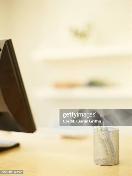 close-up of a computer and a pen stand - stand up ストックフォトと画像