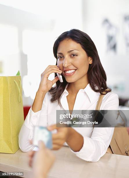 young woman making payment through a credit card - retail equipment stock pictures, royalty-free photos & images