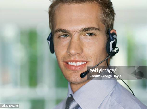 side profile of a businessman wearing a headset in an office - communication occupation stock pictures, royalty-free photos & images