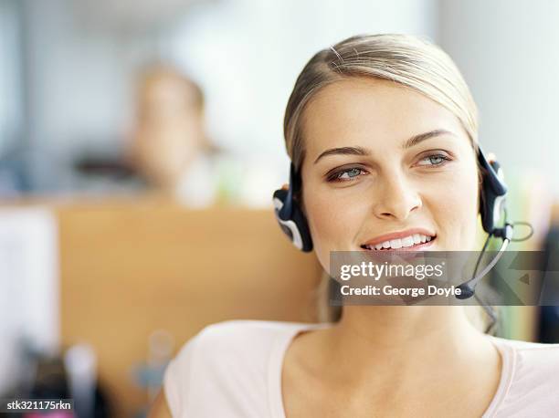 close-up of a businesswoman wearing a headset in an office - communication occupation stock pictures, royalty-free photos & images