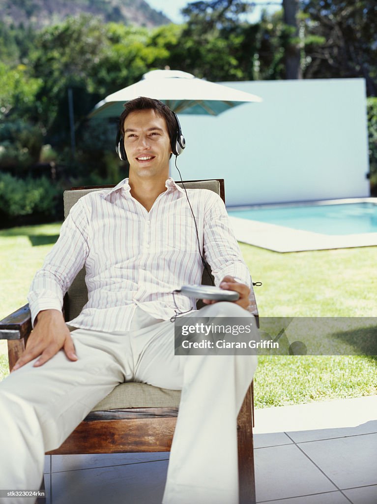 Young man wearing headphones and listening to music