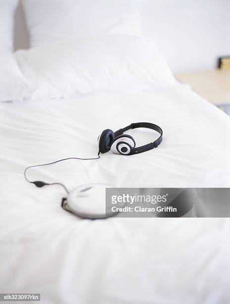 personal stereo and headphones on a bed - personal stereo stockfoto's en -beelden