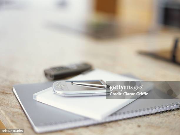 close-up of a personal data assistant on a spiral notebook - spiral foto e immagini stock