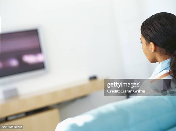 rear view of a girl watching a television - afroamerikansk kultur bildbanksfoton och bilder