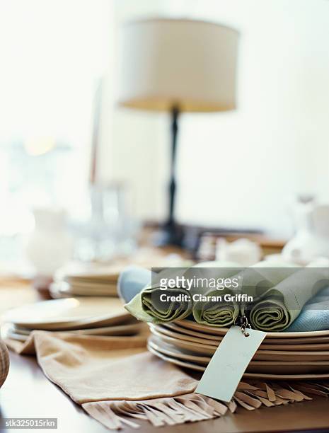 close up of napkins and plates for sale on a table - for sale stockfoto's en -beelden