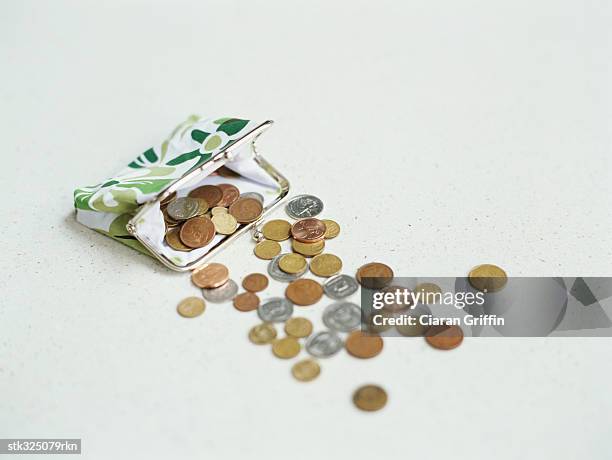 coins spilling from a purse - open purse stock pictures, royalty-free photos & images