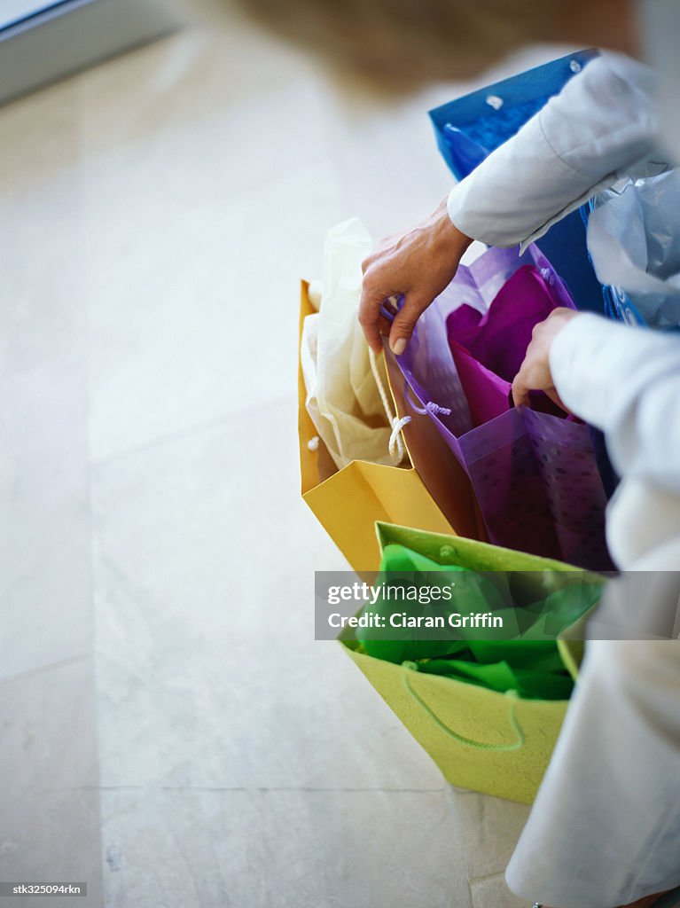 Human hand holding a shopping bag