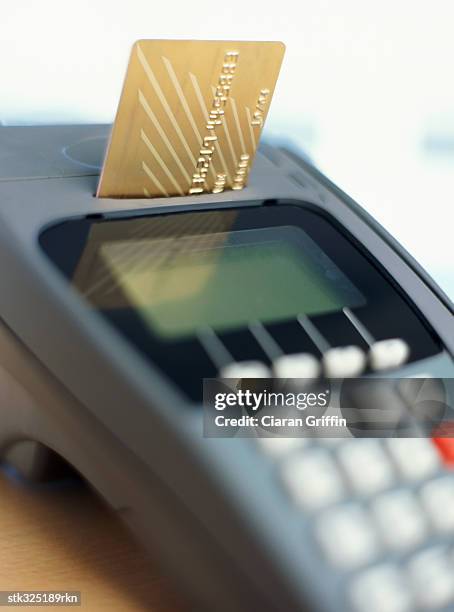 a credit card and a credit card reader - retail equipment stock pictures, royalty-free photos & images