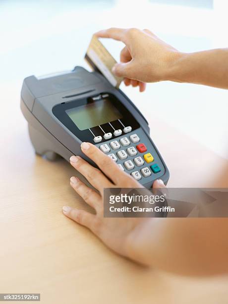 human hand swiping a credit card - retail equipment stock pictures, royalty-free photos & images