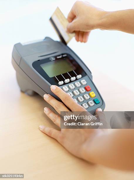 human hand swiping a credit card - retail equipment stock pictures, royalty-free photos & images