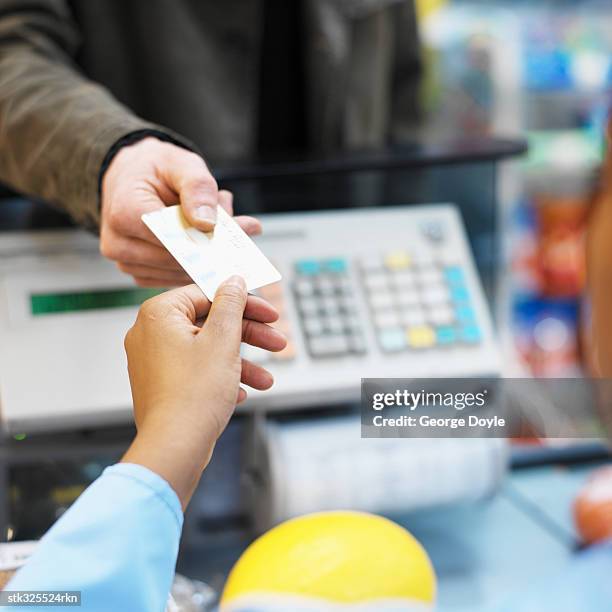 person paying through credit card at a checkout counter in a super market - equipamento de varejo - fotografias e filmes do acervo