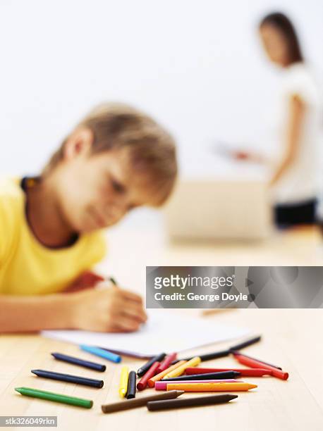 side profile of a boy drawing with colored pencil - writing instrument stock pictures, royalty-free photos & images