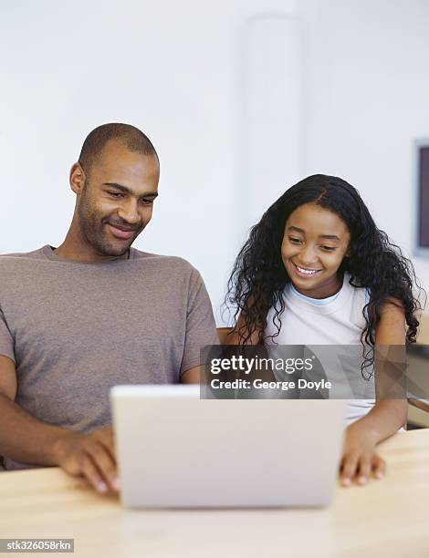 father and his daughter sitting in front of a laptop - adrienne bailon and gillette ask miami couples to kiss tell if they prefer stubble or smooth shaven stock pictures, royalty-free photos & images