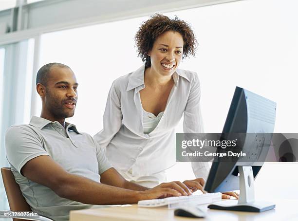 mid adult couple in front of a computer - keri hilson and gillette ask los angeles couples to kiss tell if they prefer stubble or smooth shaven stock pictures, royalty-free photos & images