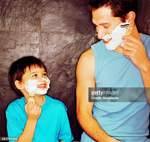 a young boy (4-6) imitating his father shaving - keri hilson and gillette ask los angeles couples to kiss tell if they prefer stubble or smooth shaven stock pictures, royalty-free photos & images