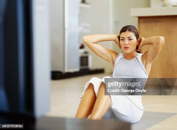 young woman exercising on the floor - exercise room stock pictures, royalty-free photos & images
