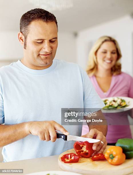 mid adult man cutting vegetables - cut out ストックフォトと画像