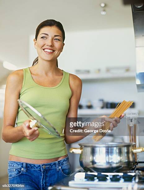 young woman preparing food in the kitchen - the kitchen bildbanksfoton och bilder
