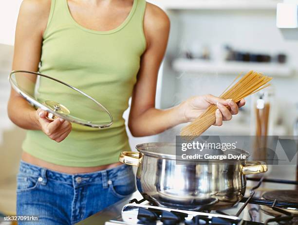 young woman preparing food in the kitchen - the kitchen bildbanksfoton och bilder