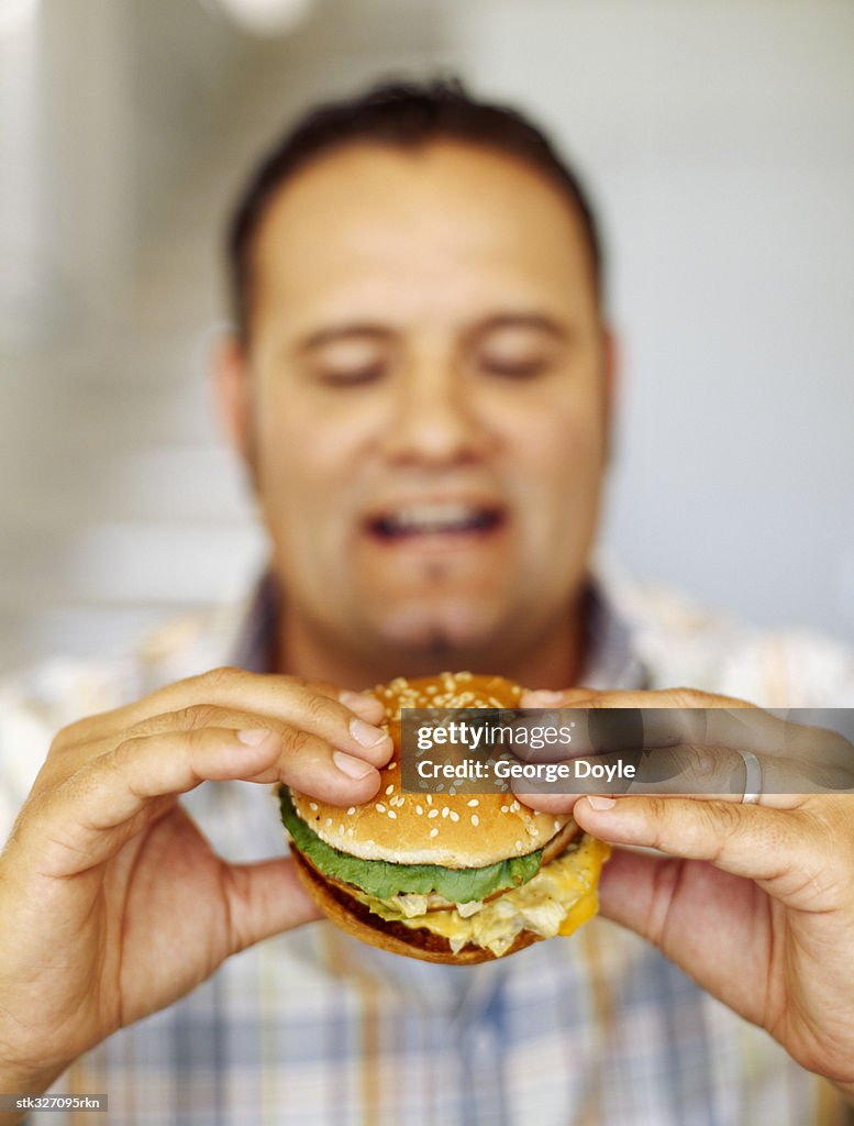 Mid adult man eating a burger