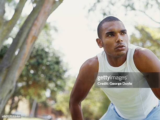 young man exercising in a park - hand on knee stock pictures, royalty-free photos & images