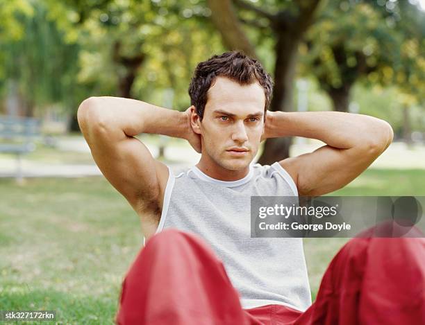 young man exercising in a park - ojos grises fotografías e imágenes de stock