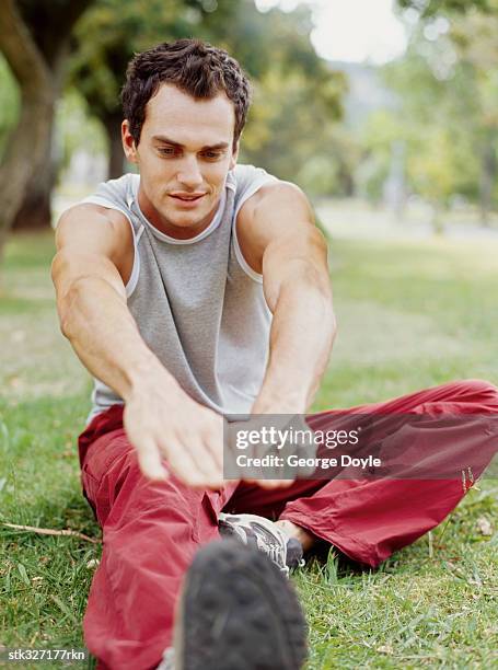 young man exercising in a park - gray eyes stock-fotos und bilder