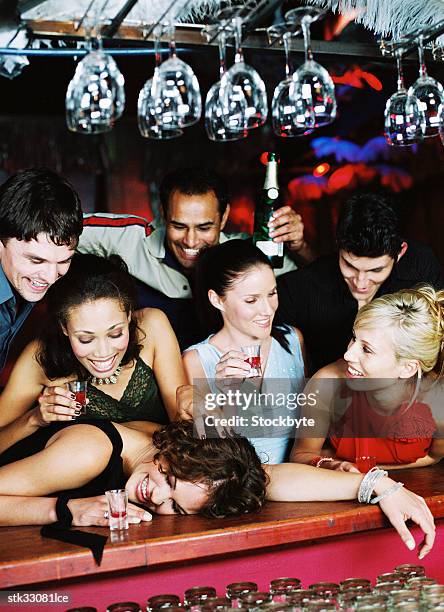 view of men and women jostling at a bar counter - bar 個照片及圖片檔