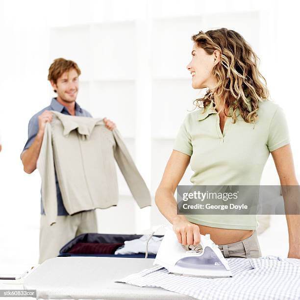 portrait of a young couple doing laundry - duing stock pictures, royalty-free photos & images