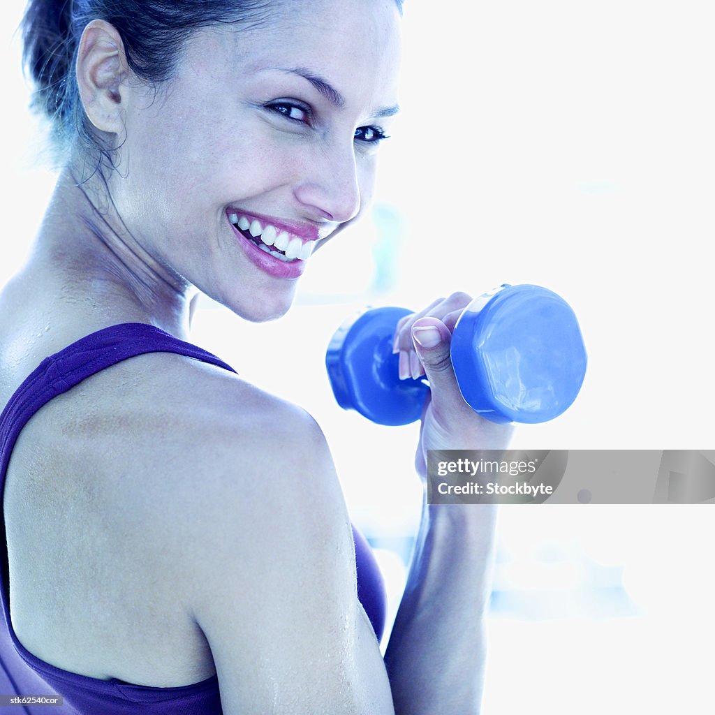 Close-up of a woman exercising using a dumbbell