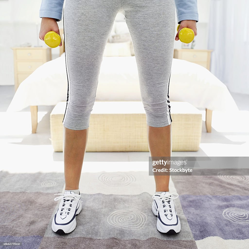 Woman standing with dumbbells