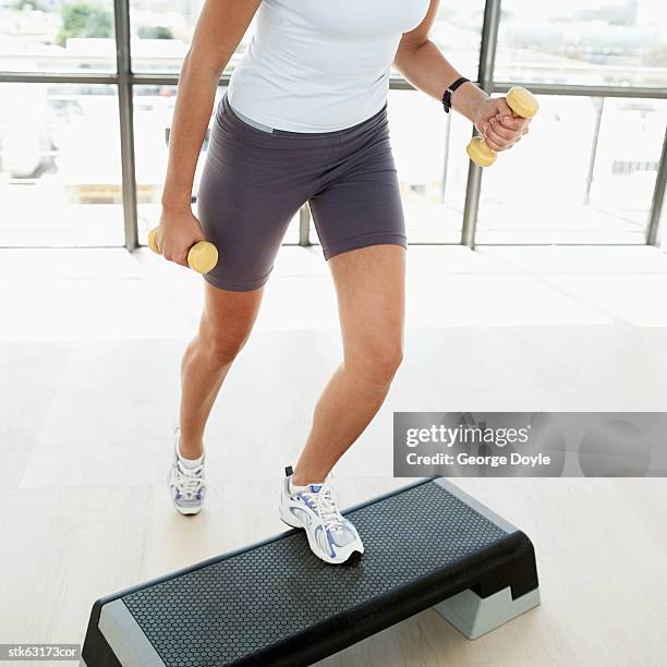 close-up of the legs of a woman working out on a stepper - anaerob träning bildbanksfoton och bilder