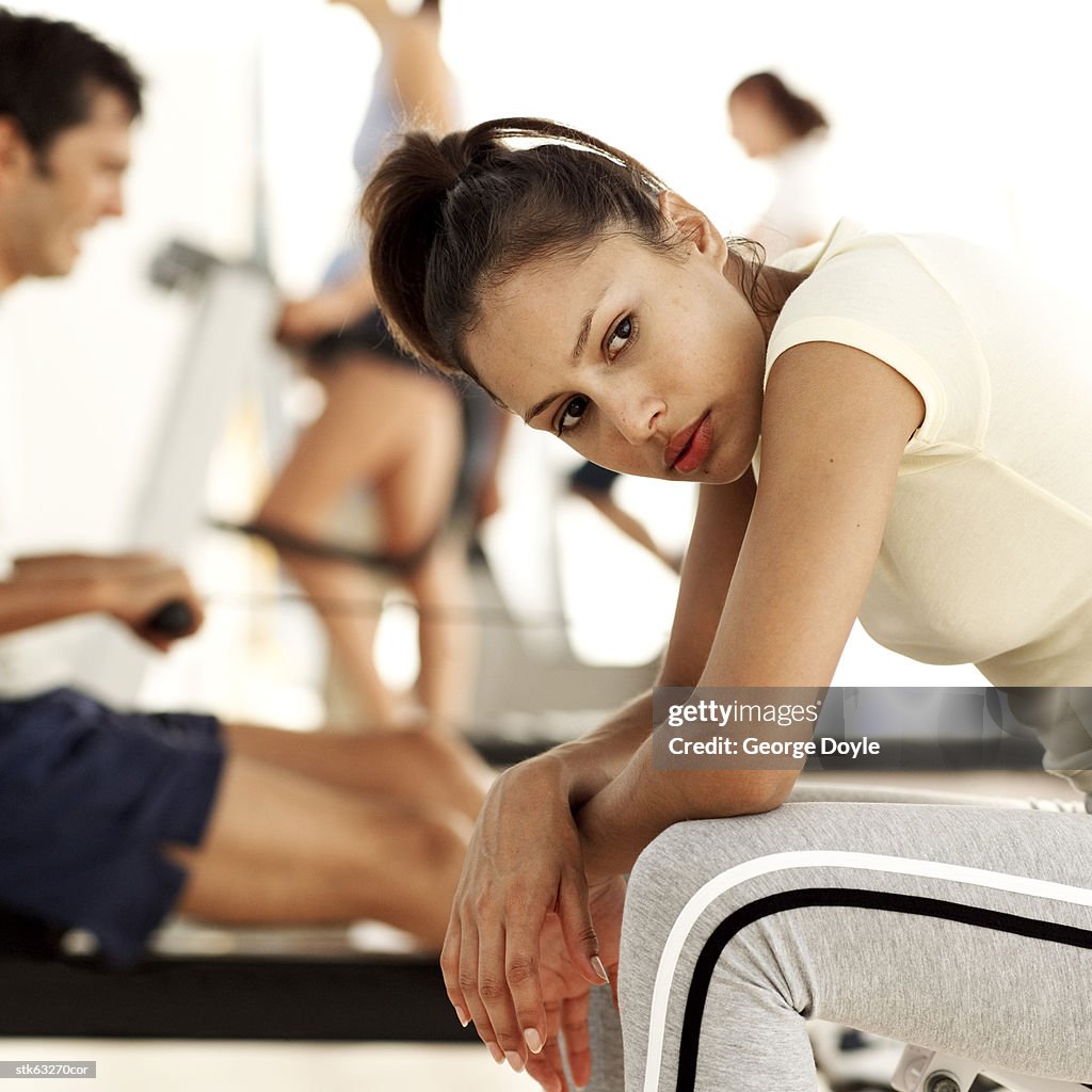 Portrait of a young woman taking a rest at the gymnasium
