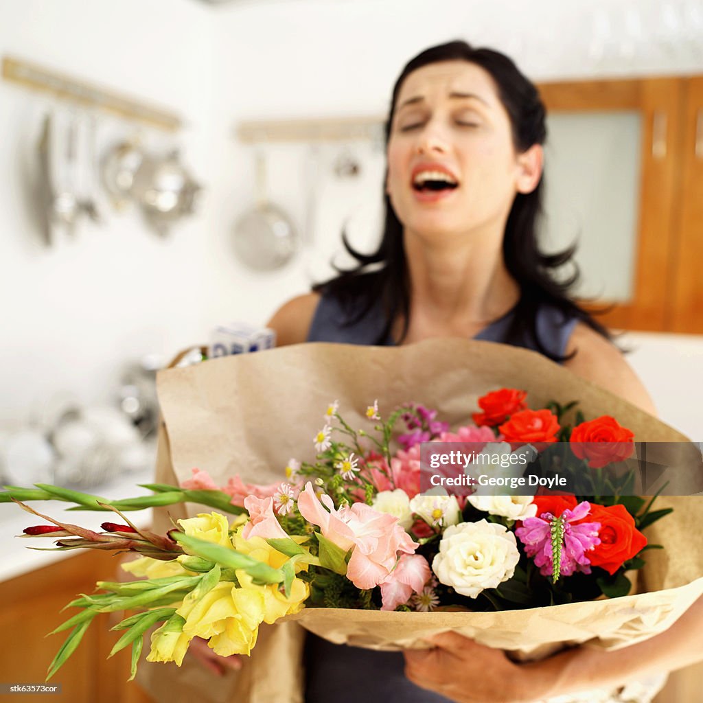 Woman carrying a bouquet of flowers