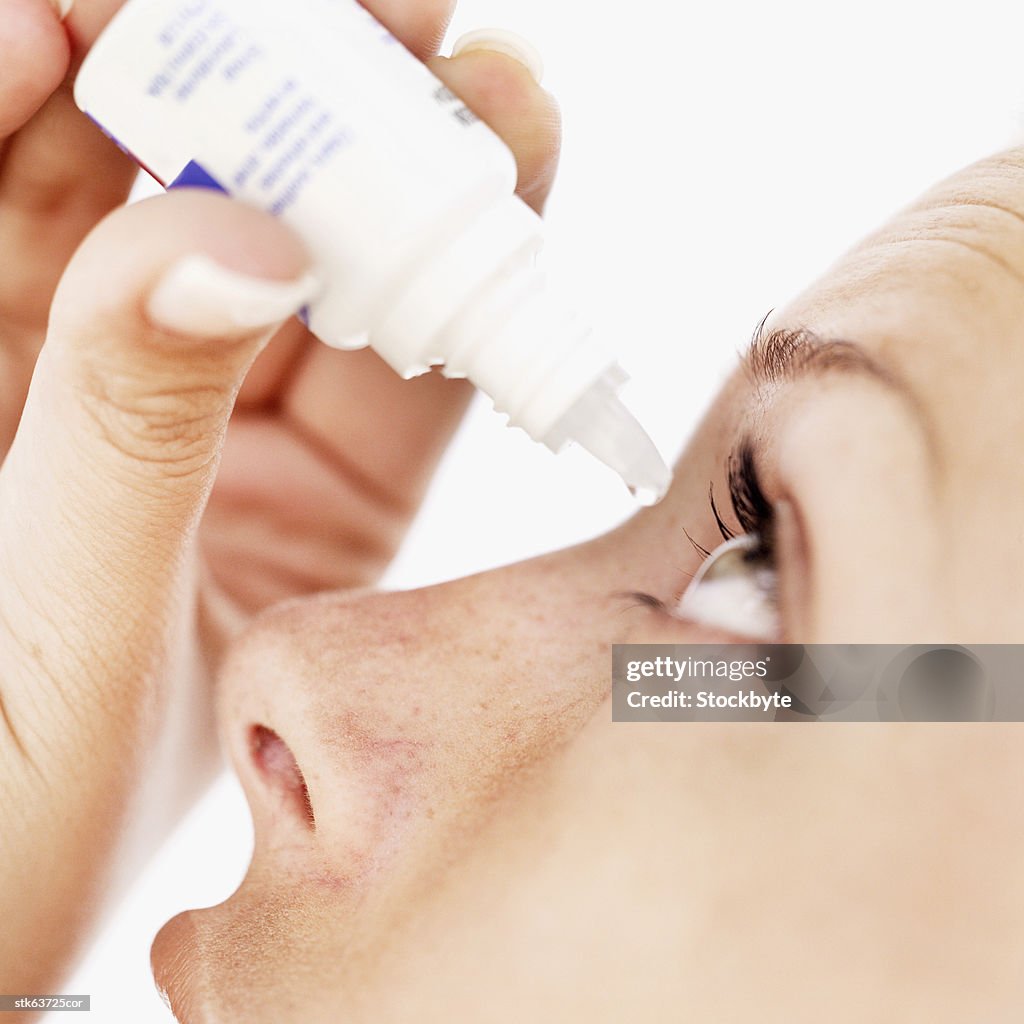 Close-up of a woman using eye drops
