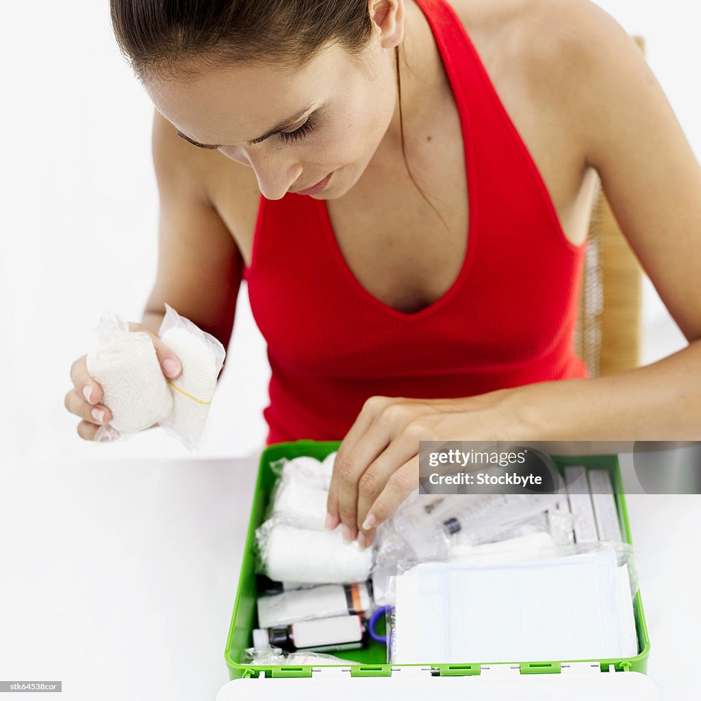 Woman looking through a first aid kit