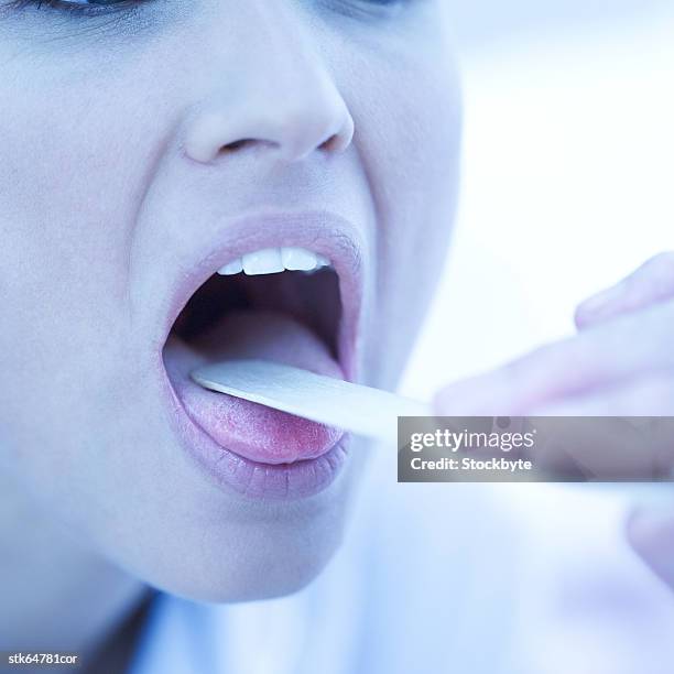 woman's throat checked with a tongue depressor - screening of la legende de la palme dor after party at china tang stockfoto's en -beelden