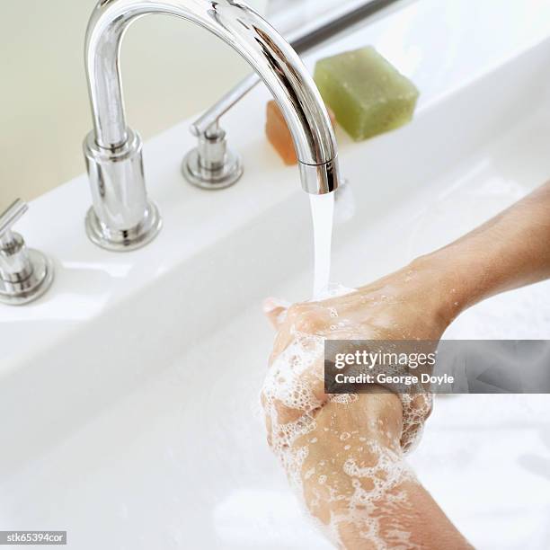 woman washing her hands - unknown gender stock pictures, royalty-free photos & images
