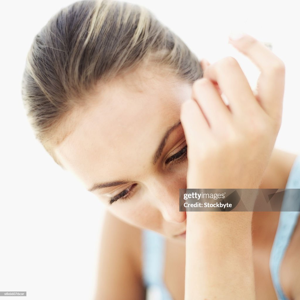 Close-up of a woman smelling perfume on her wrist