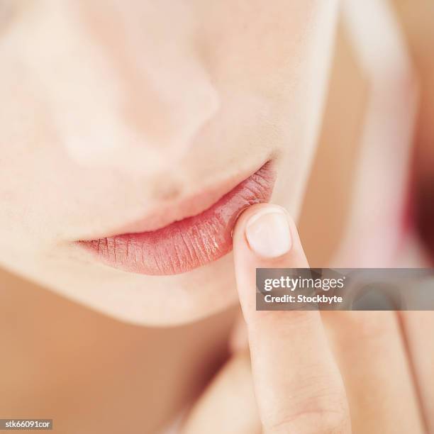 close-up of a woman applying lip balm - finger on lips bildbanksfoton och bilder